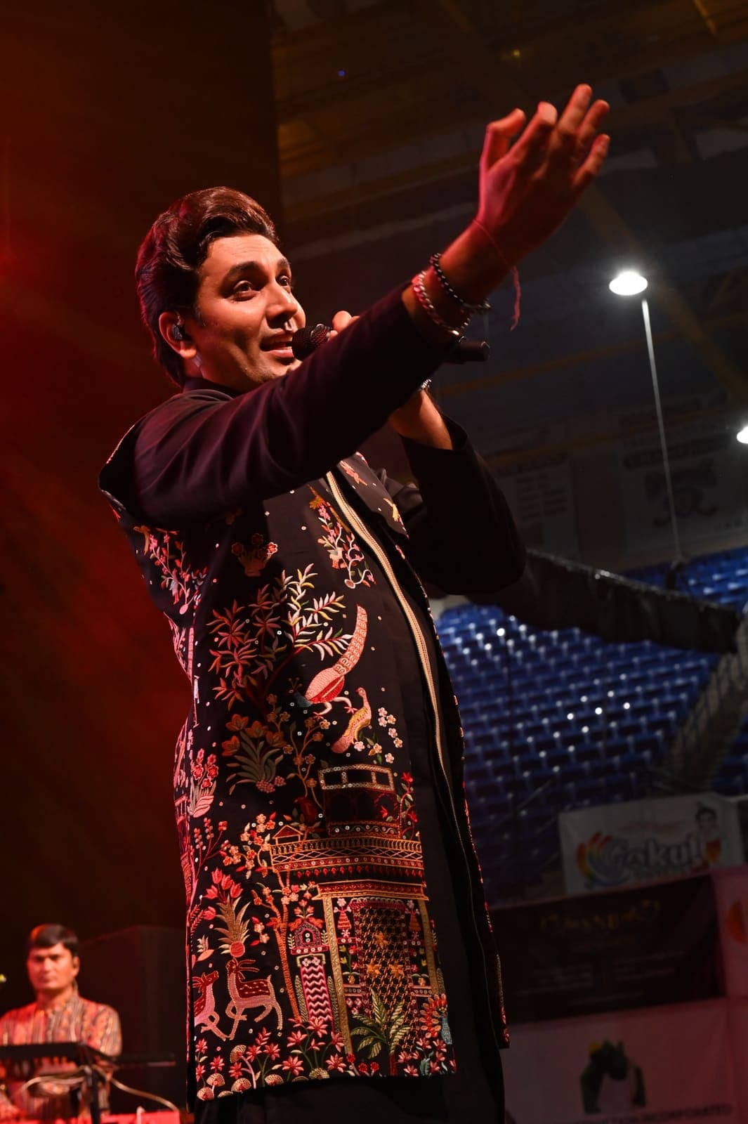 Singer performing on stage at a past Garba Night