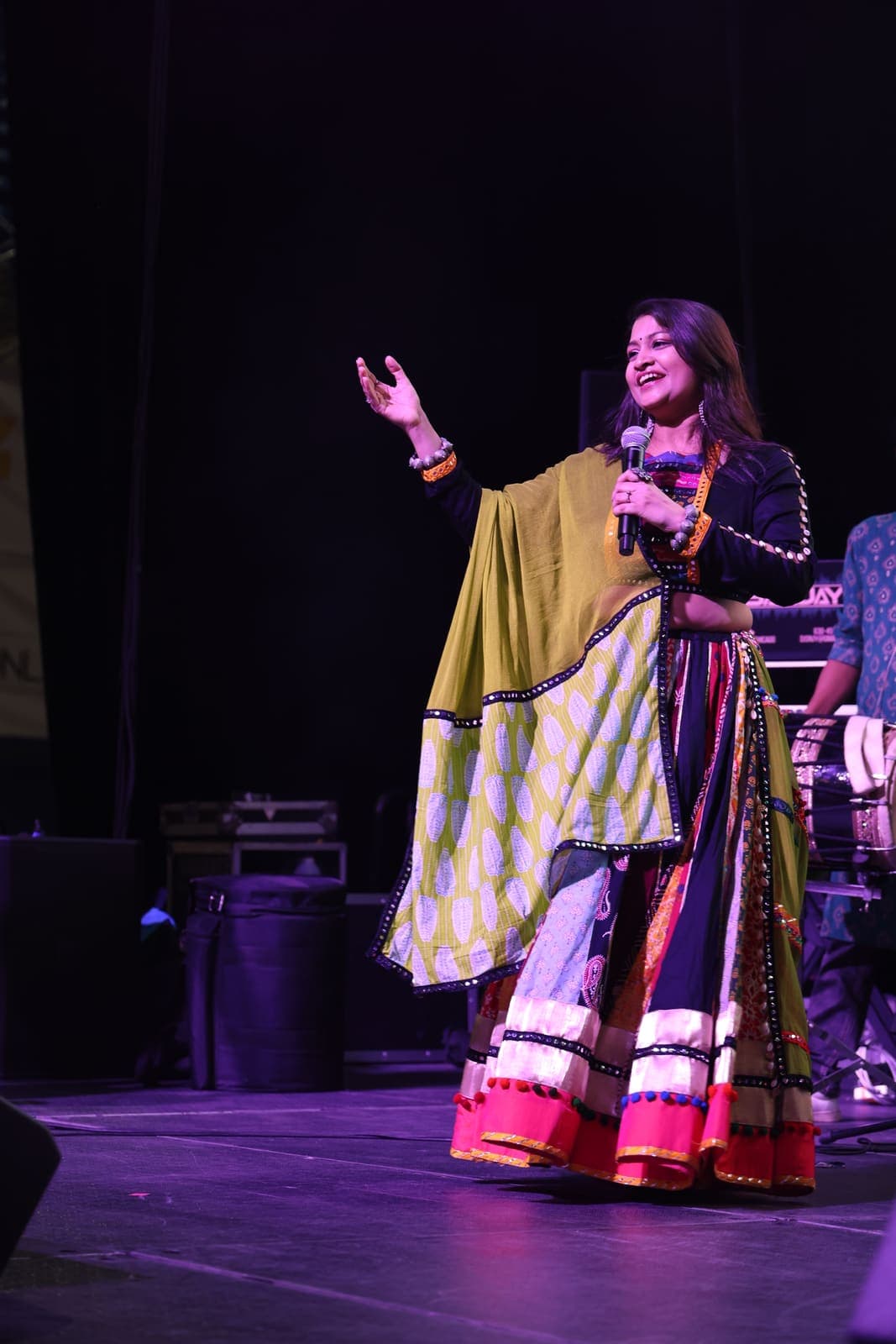 Singer performing on stage in traditional dress
